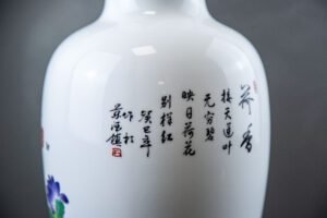 Hand-painted Jingdezhen porcelain vase with birds and blossoms on mahogany stand