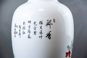 Hand-painted Jingdezhen porcelain vase with birds and blossoms on mahogany stand