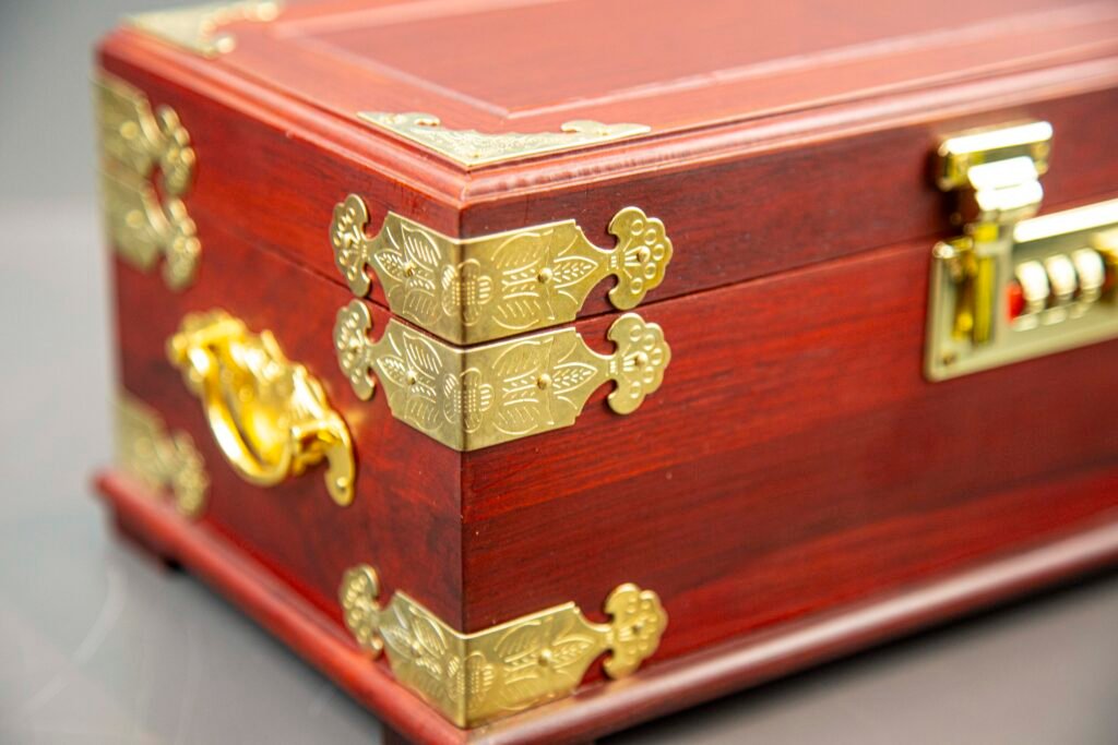 Open Chinese red velvet jewelry box with mirror and compartments Desc 1: Interior view of velvet-lined jewelry box with various storage sections