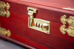 Open Chinese red velvet jewelry box with mirror and compartments Desc 1: Interior view of velvet-lined jewelry box with various storage sections